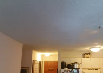 Kitchen cabinets being refinished in a professional home improvement project.