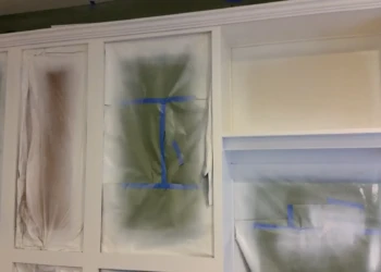 Cabinet refinishing with spray painting and masking techniques.