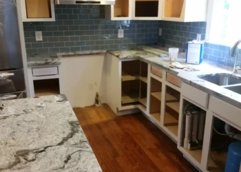 Kitchen cabinets being refinished in Concord MA, showing preparation and new finish application.