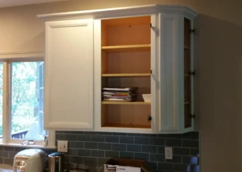 Refinished kitchen cabinets in Concord MA, showing a smooth, painted surface and updated hardware.
