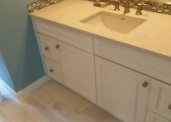 Refinished kitchen cabinets in Concord MA showing a smooth, painted surface with new hardware.