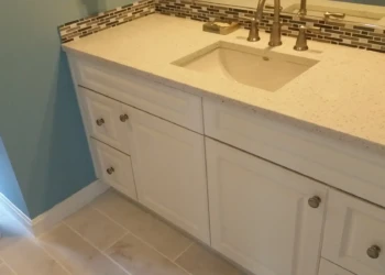 Close-up of refinished kitchen cabinets in Concord MA, showing smooth, painted surfaces and modern,.