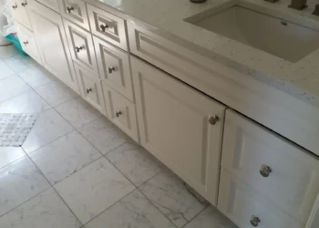 Close-up of freshly refinished white kitchen cabinets in Concord MA, showing smooth surfaces and new.