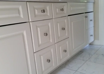 Close-up of freshly refinished white kitchen cabinets in Concord MA.