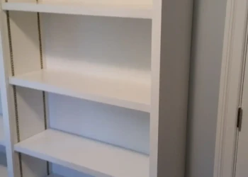 Refinished white built-in cabinet shelves in Concord MA for a fresh, clean look.
