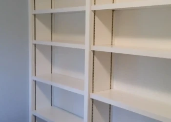 Refinished white built-in bookshelves in Concord MA for cabinet refinishing project.
