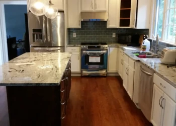 Kitchen cabinets being refinished in Concord MA, showing a clean, updated look with fresh paint and.