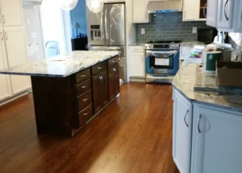 Refinished kitchen cabinets in Concord MA showing a fresh, smooth paint job and new hardware.