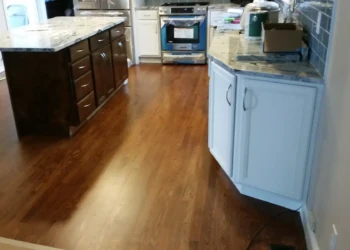 Refinished kitchen cabinets in Concord MA showing a contrast between dark and light cabinetry.