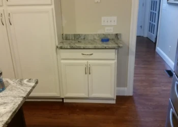 Close-up of freshly refinished kitchen cabinets in Concord MA, showing smooth, glossy surface and a.