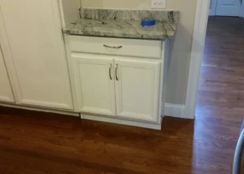 Close-up of refinished kitchen cabinet with new paint and hardware in Concord MA.
