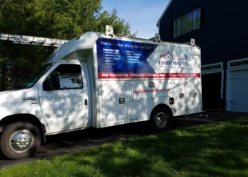 White Finish Masters Builders truck parked in a driveway near a dark blue house in Groton Massachusetts