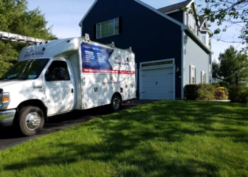 Finish Masters Builders Corp. service truck parked at blue house driveway in Groton Massachusetts