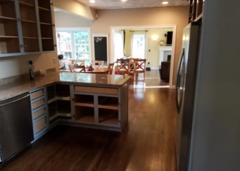 Kitchen with open cabinets and drawers prepared for cabinet refinishing in Groton MA