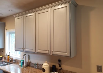 Light gray kitchen wall cabinets above granite countertop in a Groton MA kitchen cabinet refinishing project