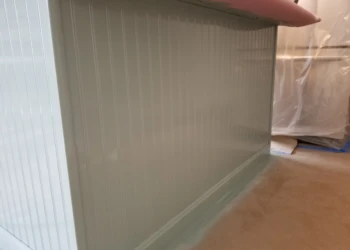 Bead board paneling applied to a kitchen island base beneath a countertop during cabinet refinishing in Merrimack NH