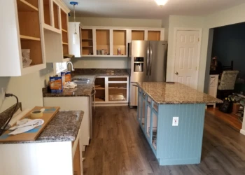 Kitchen interior with painted kitchen island and upper and lower cabinets without doors, showing refinishing work in Merrimack NH
