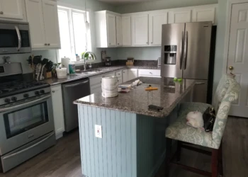 Kitchen island with blue bead board panel and white upper cabinets showing a cabinet refinishing project in Merrimack NH