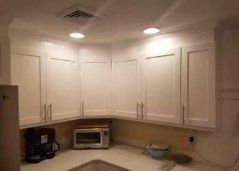 Freshly refinished white kitchen cabinets with modern handles in Nashua NH kitchen corner