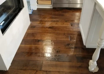Close-up view of custom kitchen cabinet doors refinished showing smooth, even wood finish in Newton MA kitchen