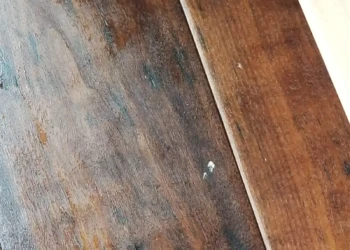 Close-up of a wood cabinet door showing finish imperfections during kitchen remodeling in Newton MA