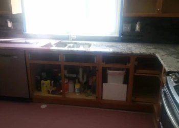 Kitchen with lower cherry wood cabinets removed and granite countertop in Sudbury MA kitchen cabinet refinishing project