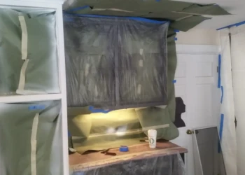 Kitchen cabinets in Sudbury MA masked and protected during refinishing preparation