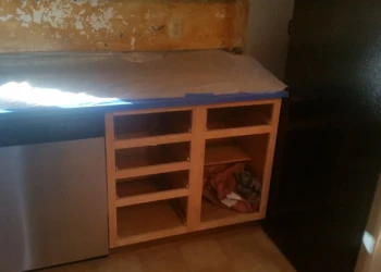Kitchen cabinets without doors or drawers next to dishwasher in Westford MA kitchen under cabinet refinishing painting