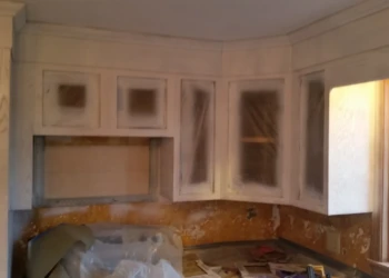 Kitchen cabinets partially refinished with primer coating during cabinet refinishing painting in Westford MA