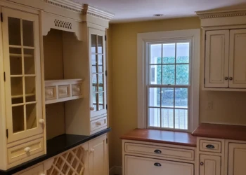 Refinished custom cabinetry with glass doors and brass hardware in a Weston MA kitchen area