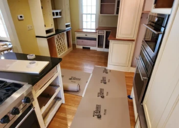 Partially remodeled kitchen in Weston MA with new black countertops and refinished white cabinets
