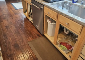 Unfinished kitchen cabinets with doors removed revealing bare wood in Windham NH kitchen