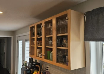 Wood kitchen cabinet frame with glass-paneled doors, stripped and prepped for refinishing in Windham NH