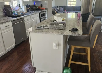 White refinished kitchen cabinets with granite countertop and stainless steel appliances in Windham kitchen