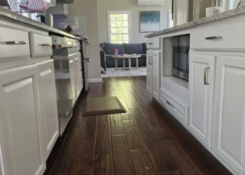 Bright kitchen with white refinished cabinets and dark wood flooring in Windham NH home