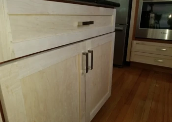 Close-up of a cabinet being refinished in a kitchen.