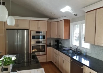 Kitchen cabinets being refinished with a smooth, new finish.