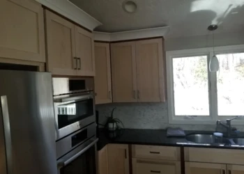 Kitchen cabinets being refinished in a home kitchen.