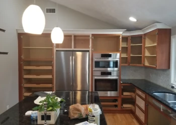 Kitchen cabinets being refinished with new stain and finish.