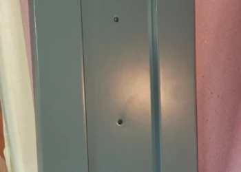 Close-up of a painted cabinet door with a recessed panel.