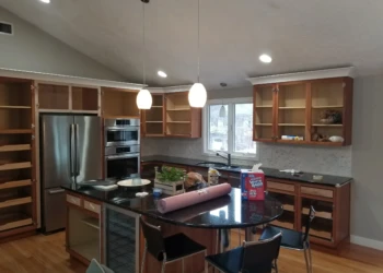 Kitchen cabinets being refinished with new stain and finish.