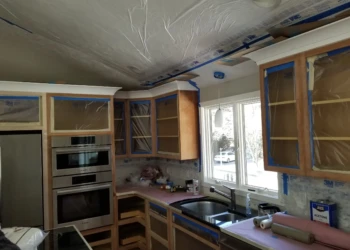 Kitchen cabinets being refinished in a home renovation project.