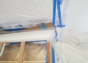Painting and refinishing cabinets in a home renovation project.