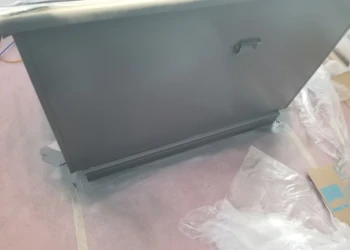 Close-up of a cabinet being refinished with a smooth, painted surface.
