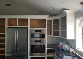 Kitchen cabinets being refinished in a home renovation project.