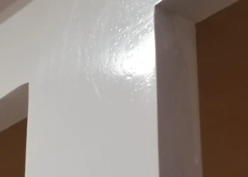 Close-up of a freshly painted white interior wall corner.