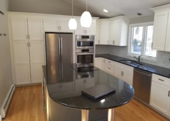 Kitchen cabinets being refinished in a modern kitchen setting.