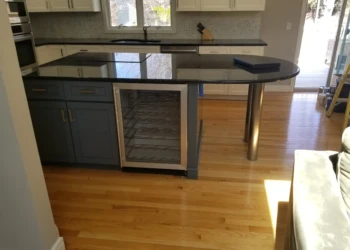 Kitchen cabinets being refinished with a smooth, glossy finish.