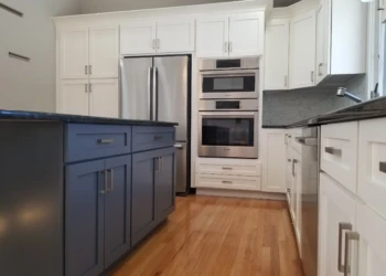 Kitchen cabinets being refinished in a modern kitchen.