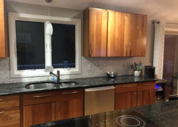 Kitchen cabinets being refinished with a smooth, polished wood finish.
